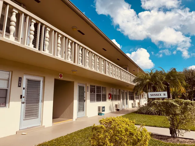 a front view of a building with a garden