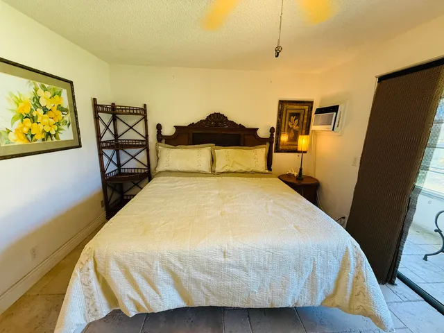 a bedroom with a bed and wall painting