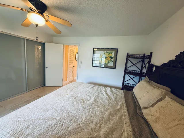 a bed room with a bed and a chandelier