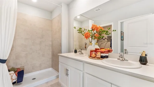 a bathroom with a sink a tub and a mirror