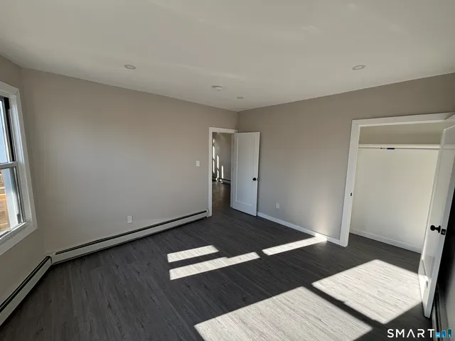a view of a room with wooden floor and window