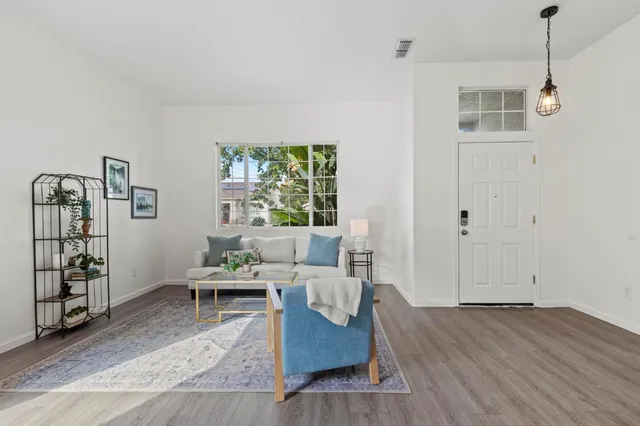 a living room with furniture potted plant and a table