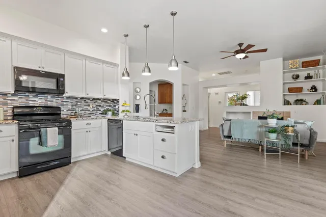 a kitchen with a refrigerator a microwave and cabinets
