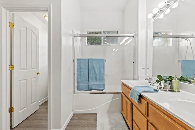 a bedroom with a bed and a painting on the wall