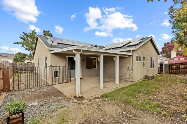 a backyard of a house with table and chairs
