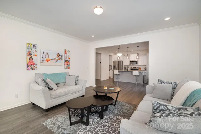 a living room with furniture and view of kitchen