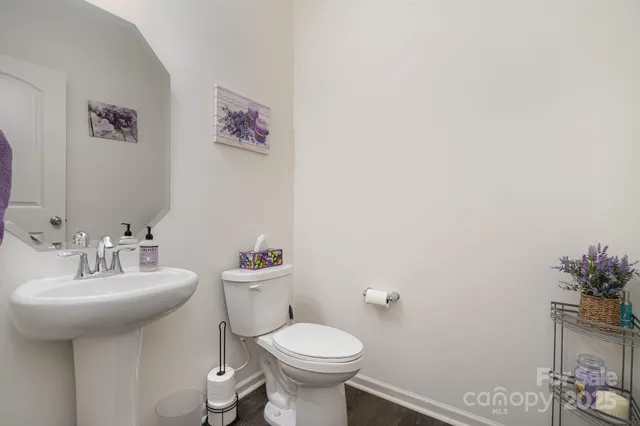 a bathroom with a sink toilet and a mirror