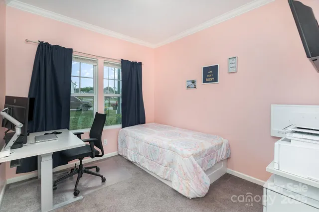 a bedroom with a bed and a desk