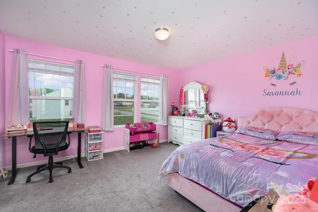 a bed room with a bed and a chair