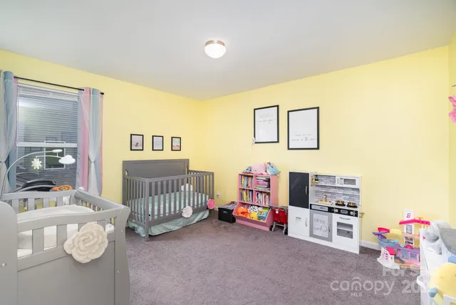 a bedroom with furniture and a baby crib