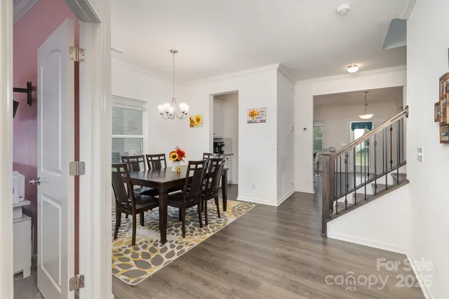 a view of a a dining room with furniture window and wooden floor
