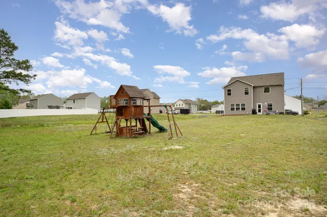 a view of a house with a yard and entertaining space