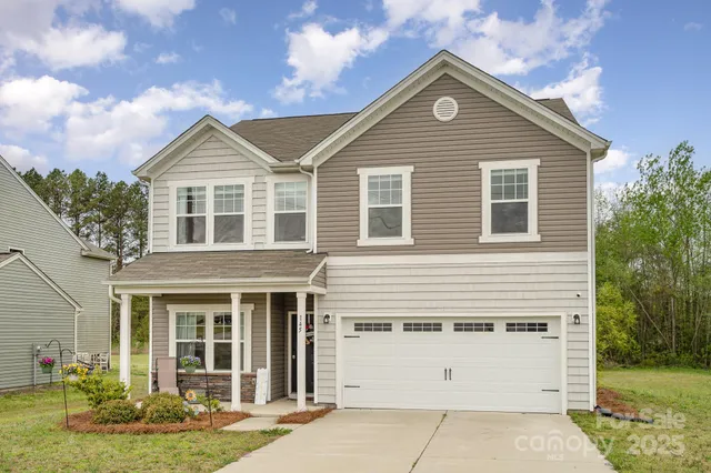 a front view of a house with garage