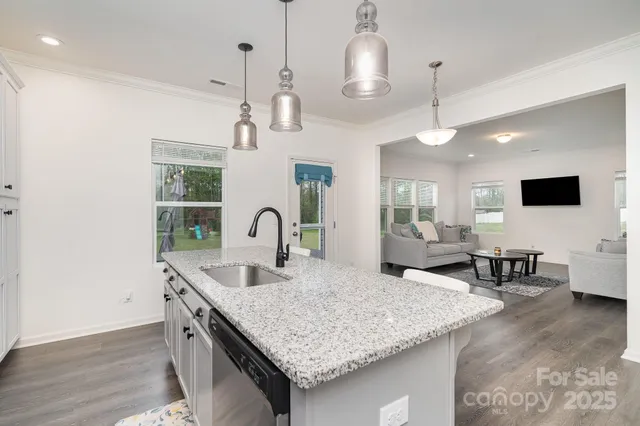 a kitchen with center island a table and chairs in it