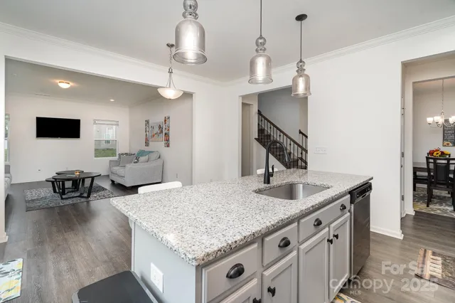 a kitchen with center island table and chairs