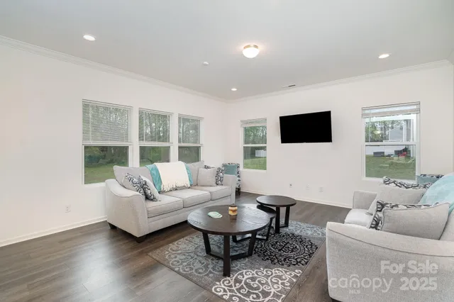 a living room with furniture a rug and a flat screen tv