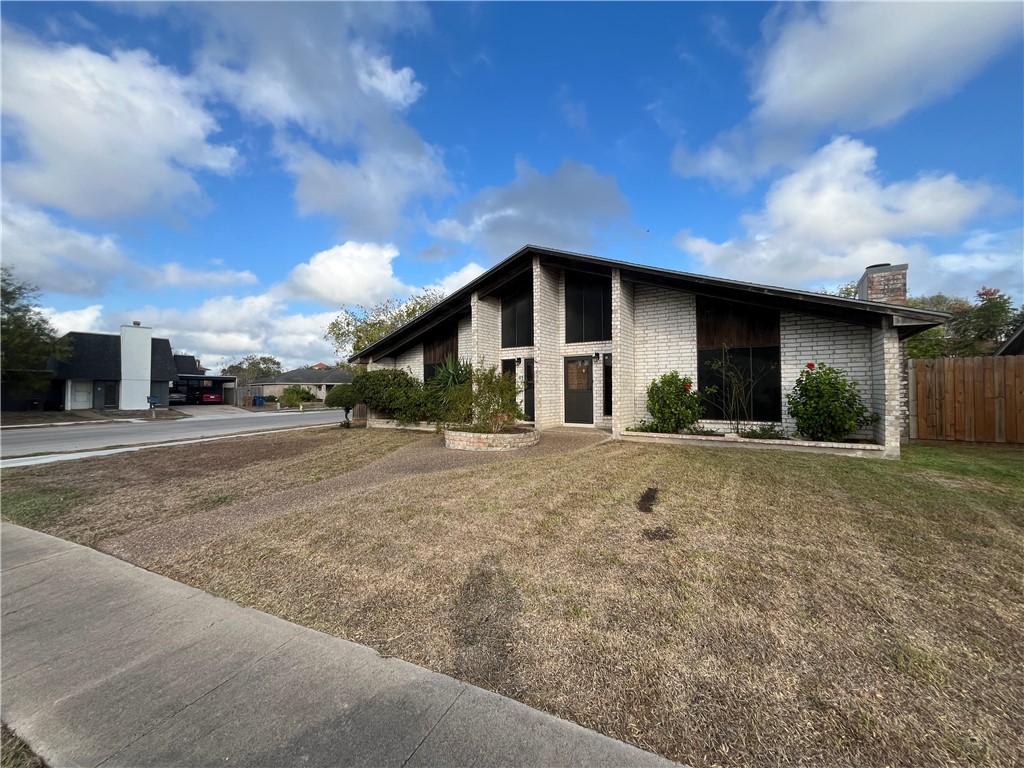 a view of a house with a yard and garage