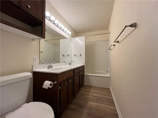 a bathroom with a double vanity sink and mirror