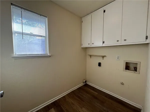 a view of storage and utility room with wooden floor