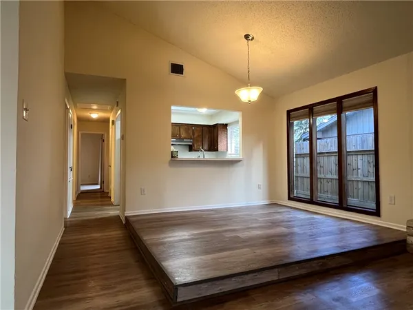 a room with wooden floor and window