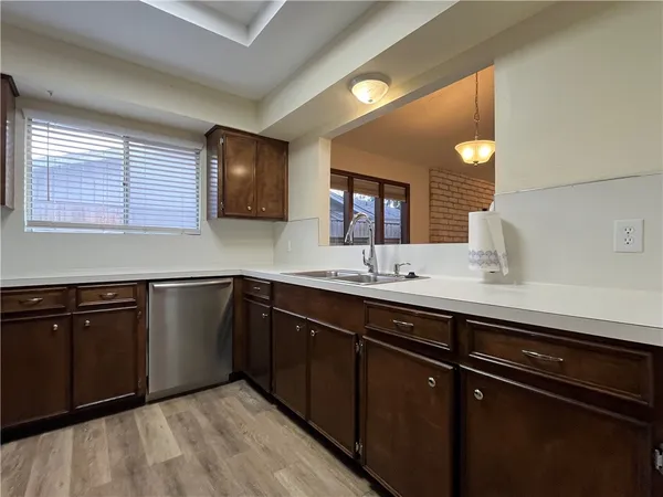 a kitchen with a sink and a wooden cabinets