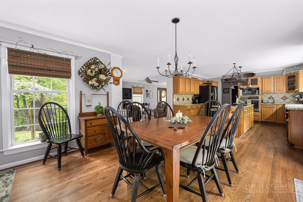970 Vox Road Sparta, NC 28675 - Photo 24 of 50 a view of a dining room and livingroom with furniture wooden floor a rug a painting and a chandelier