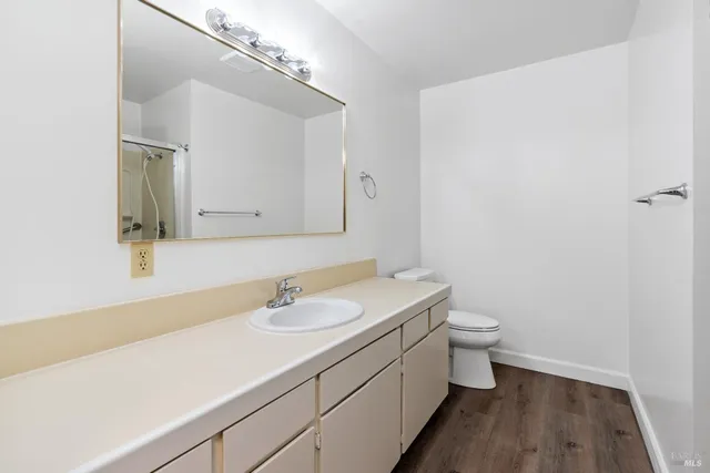 a bathroom with a sink a toilet and a mirror