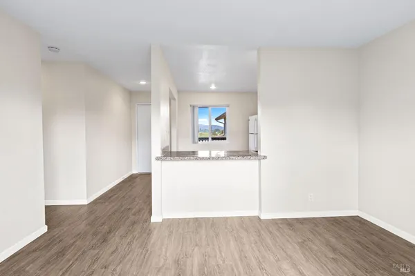 a view of a kitchen with a sink and a wooden floor