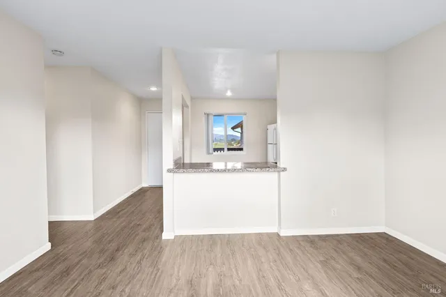 a view of a kitchen with a sink and a wooden floor