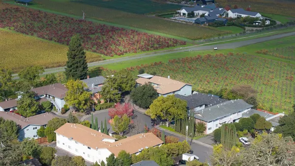 an aerial view of a house with a yard