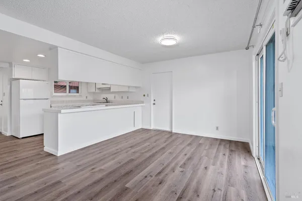 a view of kitchen with wooden floor and electronic appliances