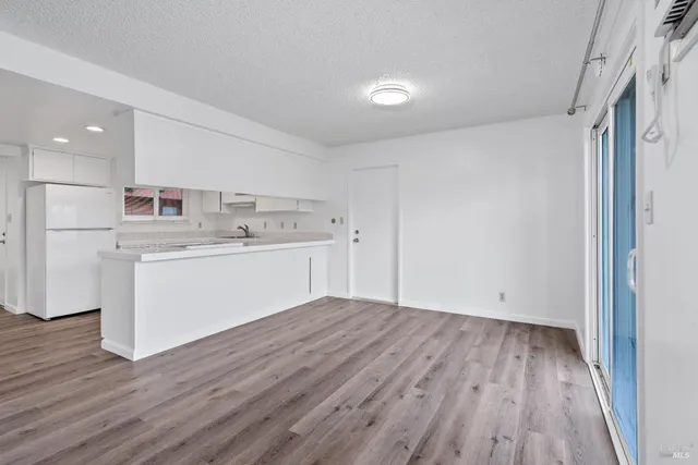 a view of kitchen with wooden floor and electronic appliances