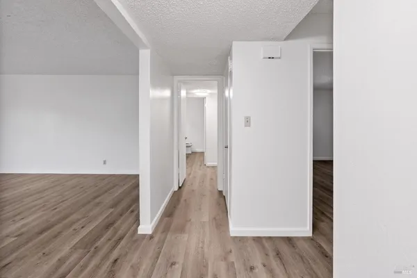 a view of a room with wooden floor