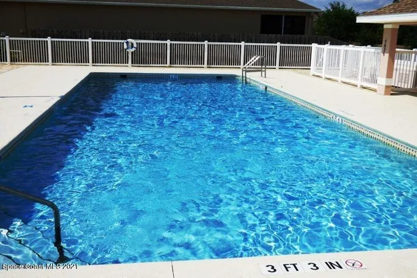 a view of a swimming pool with an outdoor seating