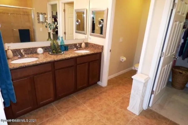 a bathroom with a double vanity sink and a mirror