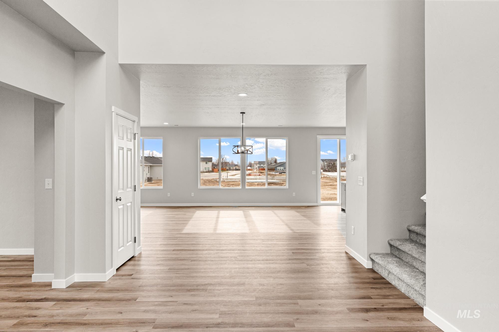 448 Merlin Court Middleton, ID 83644 - Photo 13 of 29 Vaulted ceilings, wood-finish flooring, recessed lighting, and large windows