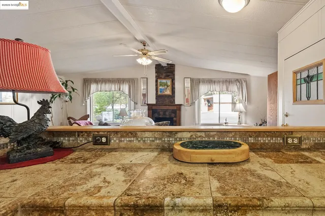 a view of a living room and kitchen area