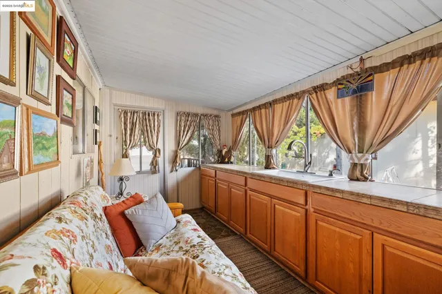 a bedroom with furniture and a large window