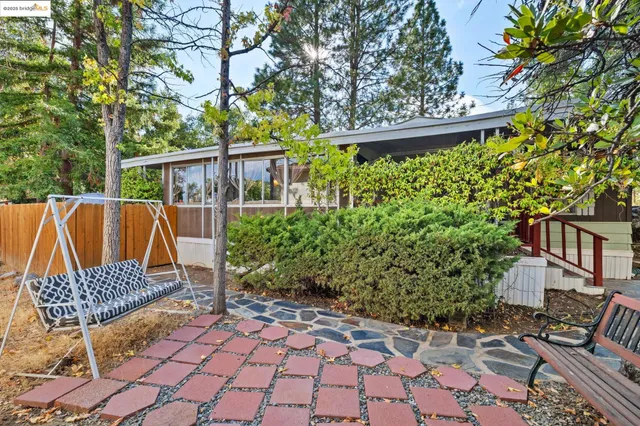 a view of a chair and tables in the backyard