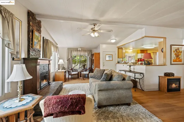 a living room with furniture ceiling fan and a table