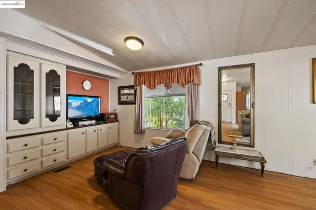 a living room with furniture fireplace and flat screen tv