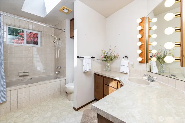 a bathroom with a sink a toilet and bathtub