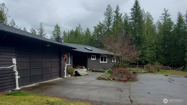 a view of a house with a yard and sitting area