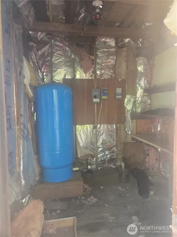 a front view of house with yard and trees in the background