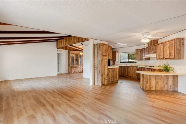 a kitchen with stainless steel appliances a refrigerator and a stove top oven