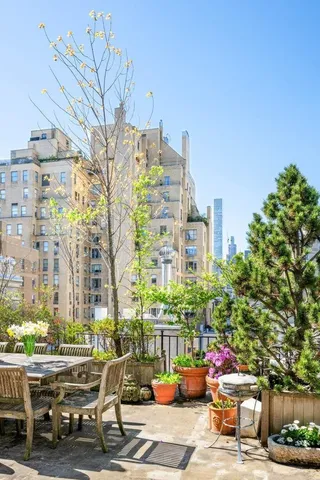 a building outdoor space with patio furniture and potted plants