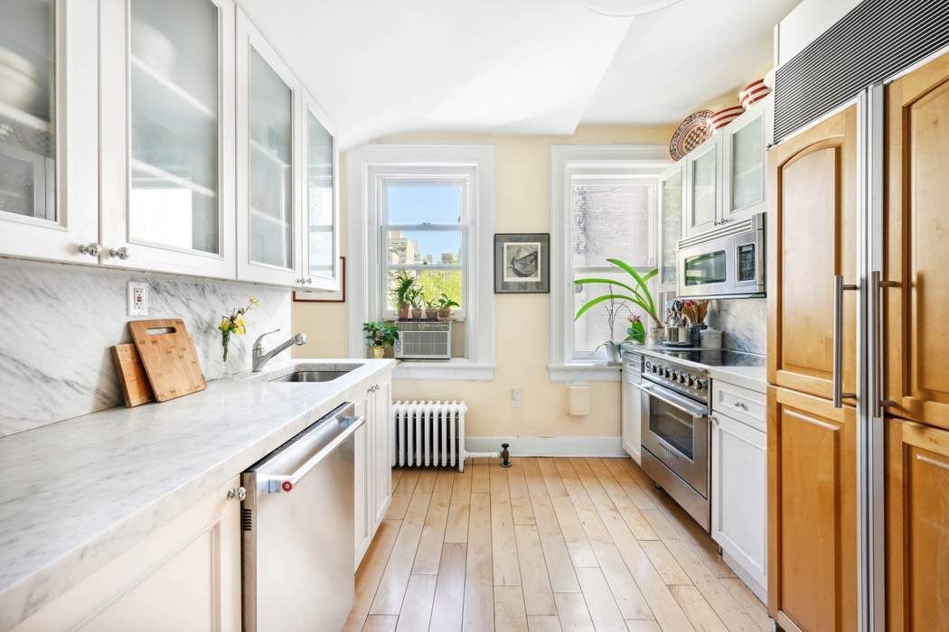 11 East 73rd Street, Unit PH Manhattan, NY 10021 - Photo 15 of 18 a kitchen with a refrigerator and a stove top oven