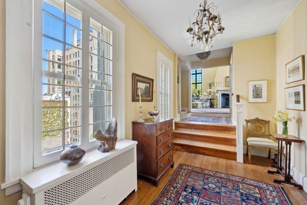 11 East 73rd Street, Unit PH Manhattan, NY 10021 - Photo 3 of 18 a living room with furniture a chandelier and a window
