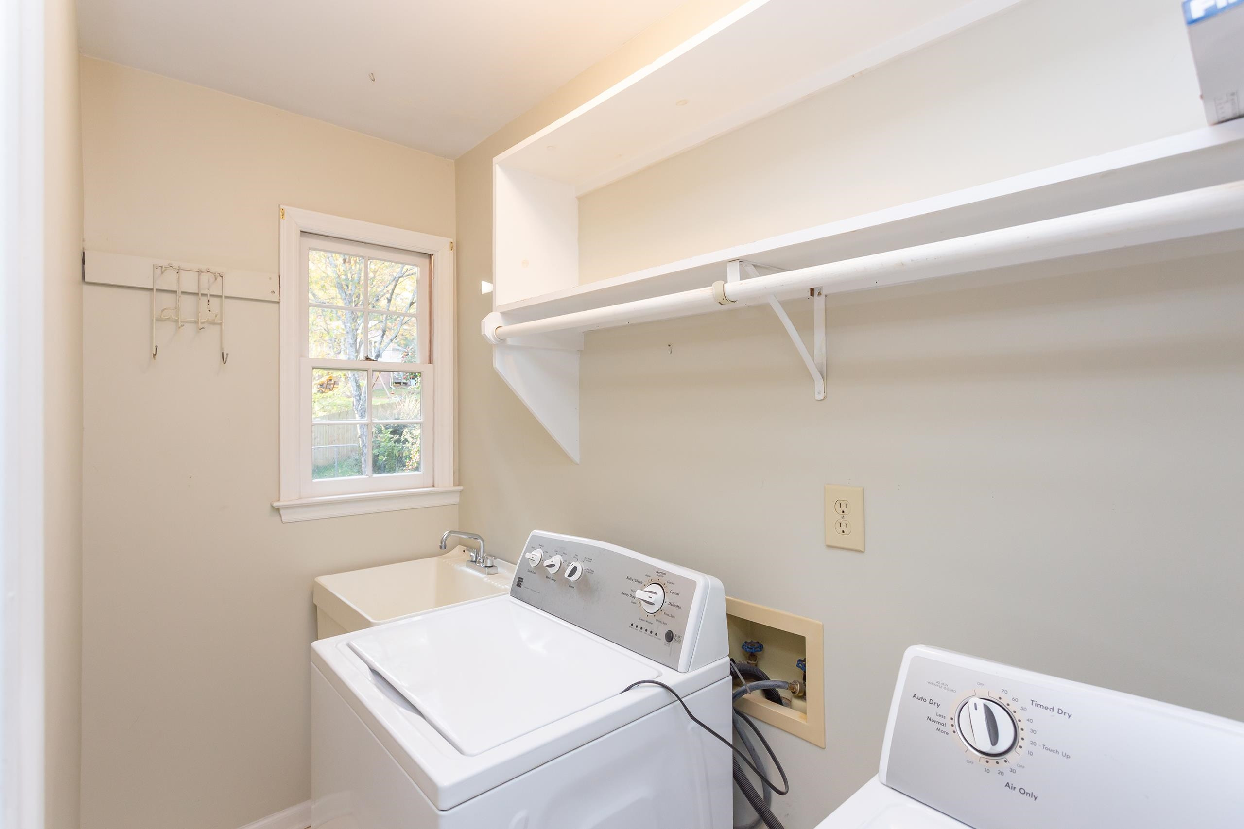 6929 Three Bridges Circle Raleigh, NC 27613 - Photo 20 of 30 Laundry room with pocket door and wash sink Laundry