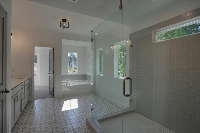 a bathroom with a shower and a glass door
